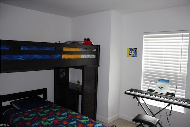 carpeted bedroom with baseboards