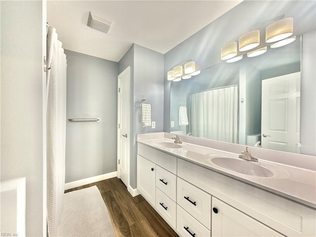 107 Mill Creek Rd, Edenton, NC 27932 - full bath with wood finished floors, double vanity, baseboards, and a shower with curtain