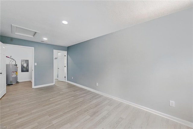725 Burgesses Ln, Virginia Beach, VA 23452 - unfurnished room featuring light wood-style floors, baseboards, water heater, and electric panel