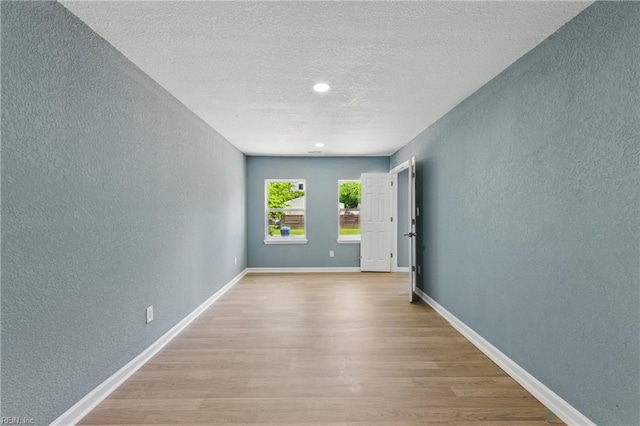 725 Burgesses Ln, Virginia Beach, VA 23452 - unfurnished room featuring baseboards, a textured ceiling, a textured wall, and wood finished floors