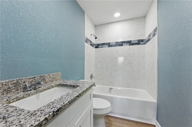 725 Burgesses Ln, Virginia Beach, VA 23452 - bathroom with a textured wall, toilet, wood finished floors, and shower / washtub combination