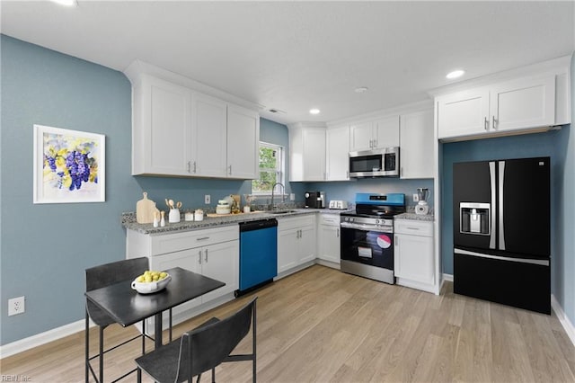 725 Burgesses Ln, Virginia Beach, VA 23452 - kitchen with appliances with stainless steel finishes, light wood-type flooring, a sink, recessed lighting, and white cabinetry