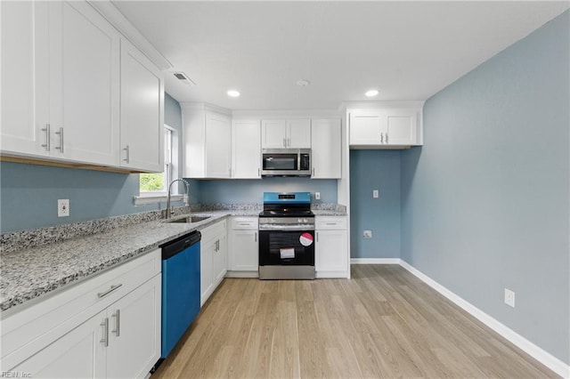 725 Burgesses Ln, Virginia Beach, VA 23452 - kitchen with white cabinets, stainless steel appliances, a sink, and light wood-style floors