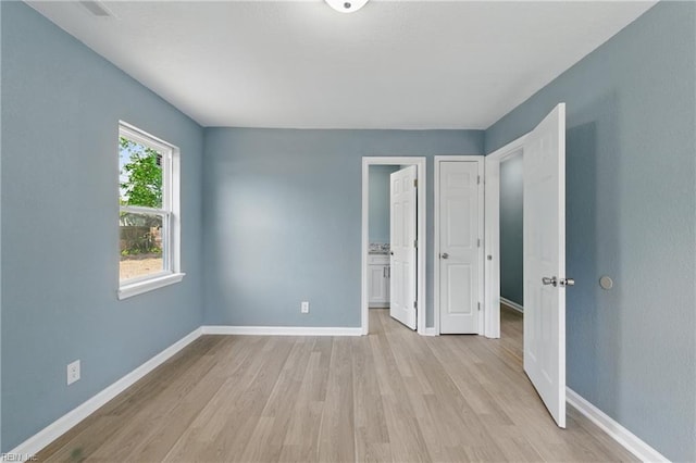 725 Burgesses Ln, Virginia Beach, VA 23452 - unfurnished bedroom featuring light wood-style floors and baseboards