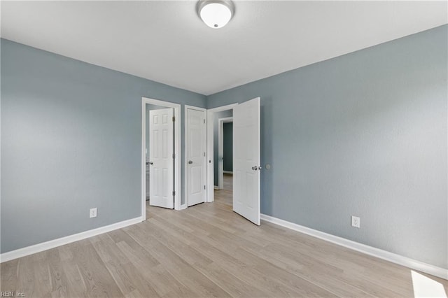 725 Burgesses Ln, Virginia Beach, VA 23452 - unfurnished bedroom with baseboards and light wood-style flooring