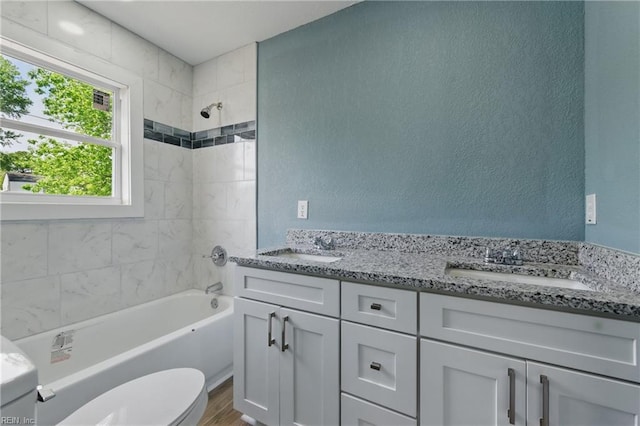 725 Burgesses Ln, Virginia Beach, VA 23452 - bathroom featuring a textured wall, wood finished floors, toilet, bathtub / shower combination, and a sink