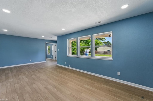 725 Burgesses Ln, Virginia Beach, VA 23452 - empty room featuring baseboards, a textured ceiling, visible vents, and wood finished floors