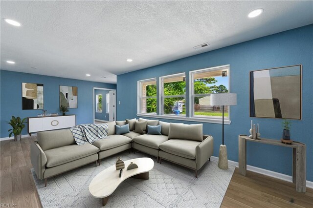 725 Burgesses Ln, Virginia Beach, VA 23452 - living area featuring a textured ceiling, visible vents, wood finished floors, baseboards, and recessed lighting
