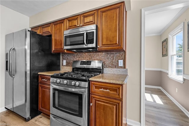 1101 Revelstroke Ct, Virginia Beach, VA 23454 - kitchen with stainless steel appliances, light wood finished floors, backsplash, brown cabinets, and ornamental molding
