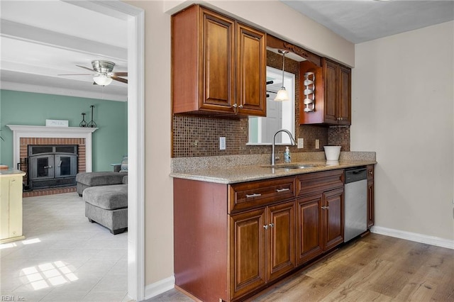1101 Revelstroke Ct, Virginia Beach, VA 23454 - kitchen featuring a sink, stainless steel dishwasher, ceiling fan, baseboards, and backsplash