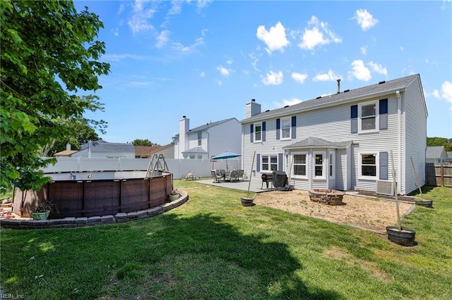 1101 Revelstroke Ct, Virginia Beach, VA 23454 - rear view of house featuring an outdoor pool, a fire pit, a patio, and a chimney