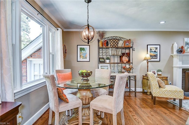 dining room with baseboards, a notable chandelier, plenty of natural light, and wood finished floors