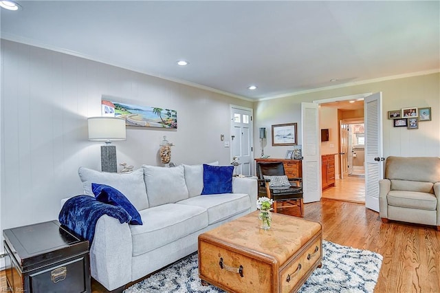 living area with recessed lighting, ornamental molding, and light wood finished floors