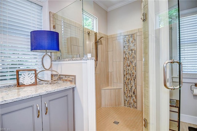 full bathroom with a shower stall, ornamental molding, and vanity