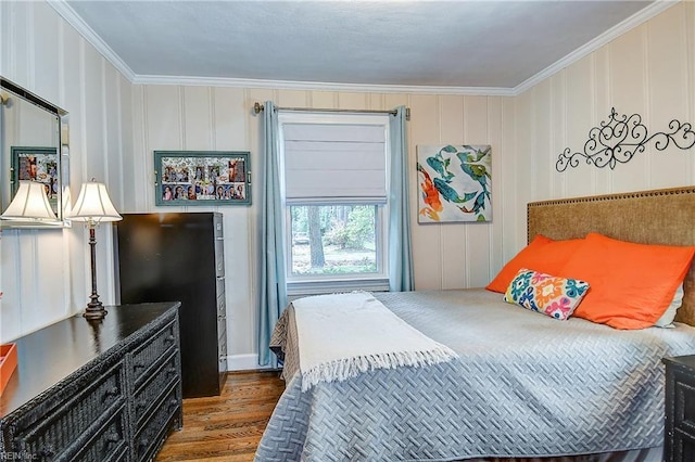 bedroom with ornamental molding and wood finished floors