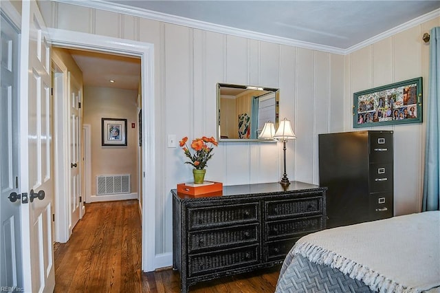bedroom featuring dark wood-style flooring, baseboards, visible vents, and ornamental molding