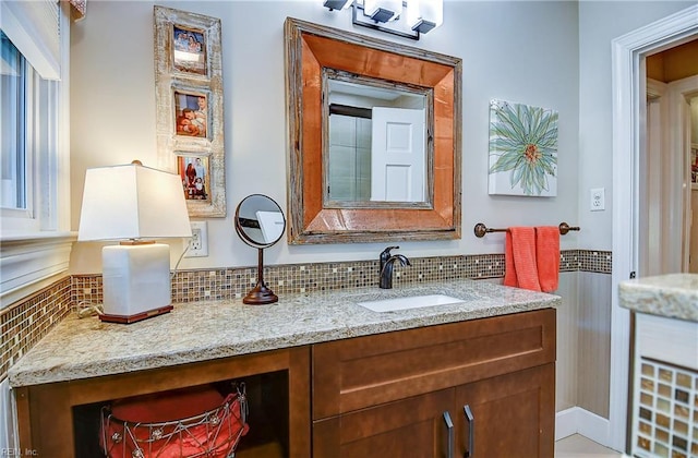 bathroom with vanity and decorative backsplash