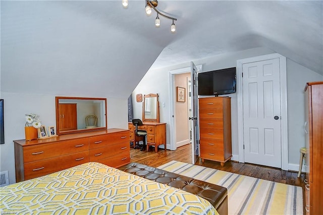 bedroom featuring visible vents, lofted ceiling, and dark wood-type flooring