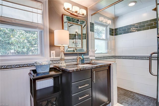 bathroom featuring vanity and a tile shower
