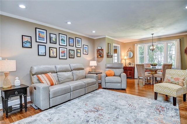 living area with ornamental molding, recessed lighting, and wood finished floors