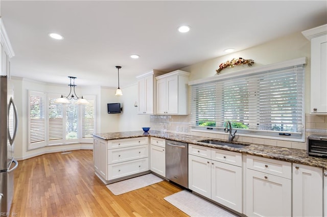 200 Moodys Run, Williamsburg, VA 23185 - kitchen with appliances with stainless steel finishes, a sink, a peninsula, white cabinetry, and backsplash