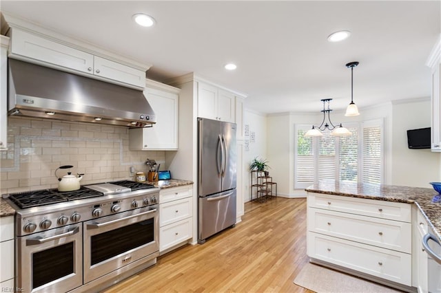 200 Moodys Run, Williamsburg, VA 23185 - kitchen with stainless steel appliances, under cabinet range hood, ornamental molding, backsplash, and white cabinetry