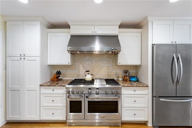 200 Moodys Run, Williamsburg, VA 23185 - kitchen with appliances with stainless steel finishes, wall chimney range hood, light stone counters, white cabinets, and recessed lighting