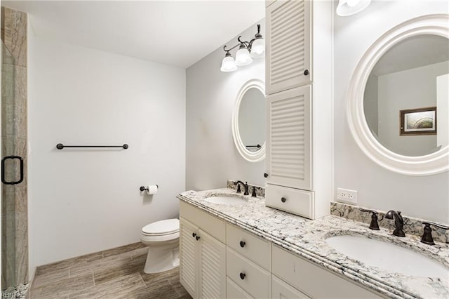 200 Moodys Run, Williamsburg, VA 23185 - full bath with toilet, double vanity, a shower with shower door, and wood finished floors
