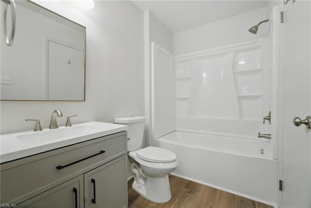 full bath featuring vanity, wood finished floors, bathtub / shower combination, and toilet