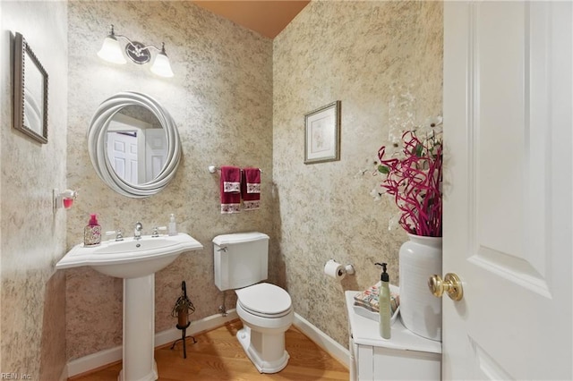 bathroom featuring toilet and wood finished floors
