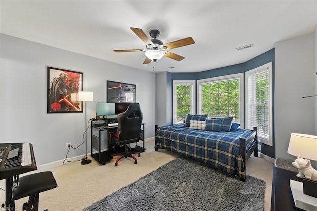 carpeted bedroom featuring visible vents, a ceiling fan, and baseboards
