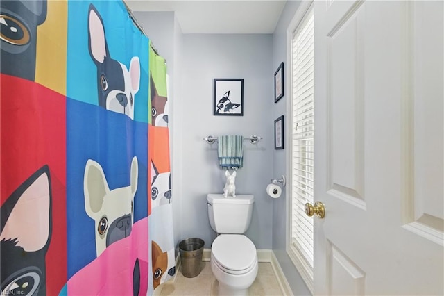 bathroom with toilet, baseboards, a shower with shower curtain, and tile patterned flooring