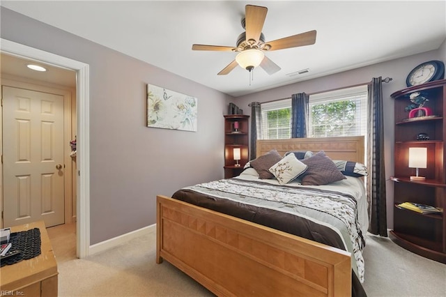 bedroom featuring a ceiling fan, baseboards, visible vents, and light carpet
