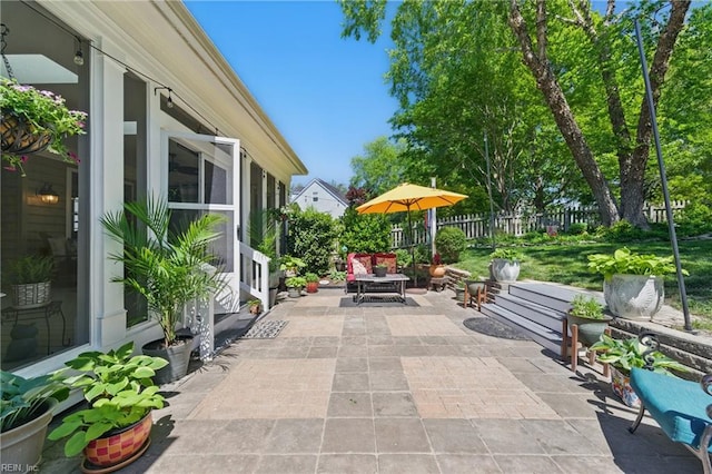view of patio featuring fence