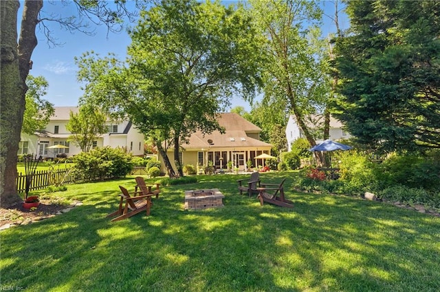 view of yard with a fire pit and fence