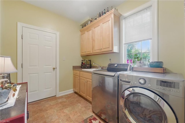 laundry area featuring independent washer and dryer, a sink, and cabinet space
