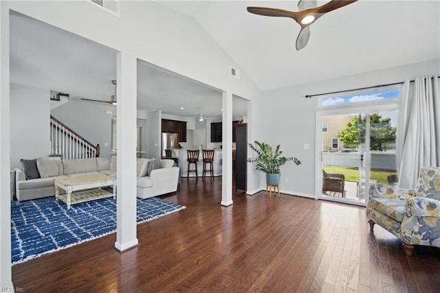 living area featuring visible vents, a ceiling fan, dark wood finished floors, and stairway