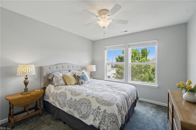 carpeted bedroom featuring baseboards, a ceiling fan, and visible vents