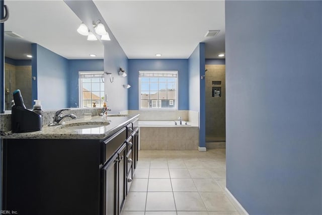 full bathroom featuring a sink, tile patterned floors, a stall shower, and a garden tub