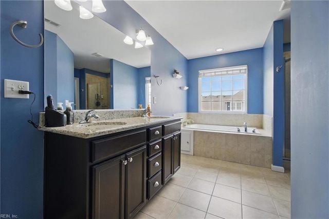 bathroom with tile patterned flooring, double vanity, a bath, a sink, and a stall shower