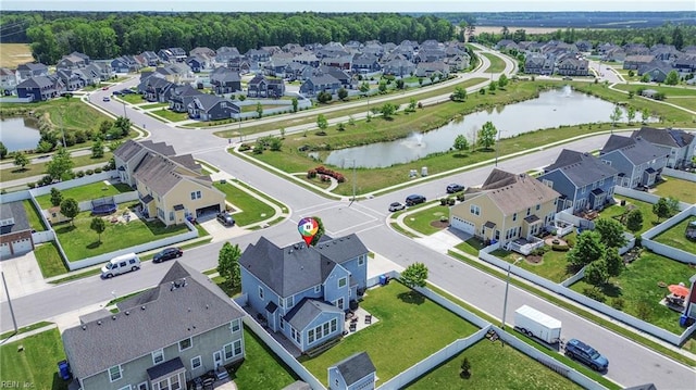 drone / aerial view with a water view and a residential view