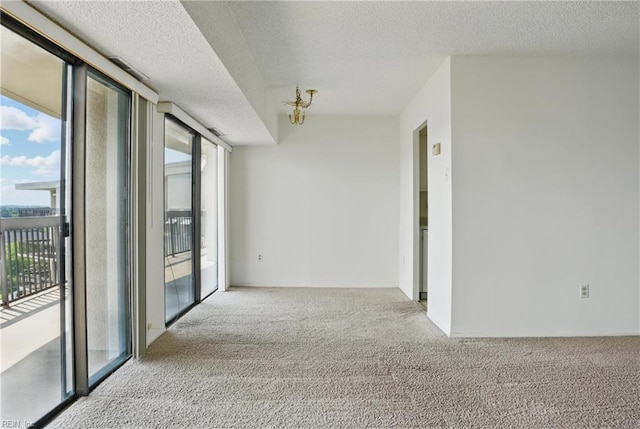 2830 Shore Dr Unit 900, Virginia Beach, VA 23451 - carpeted empty room with a textured ceiling and a wealth of natural light