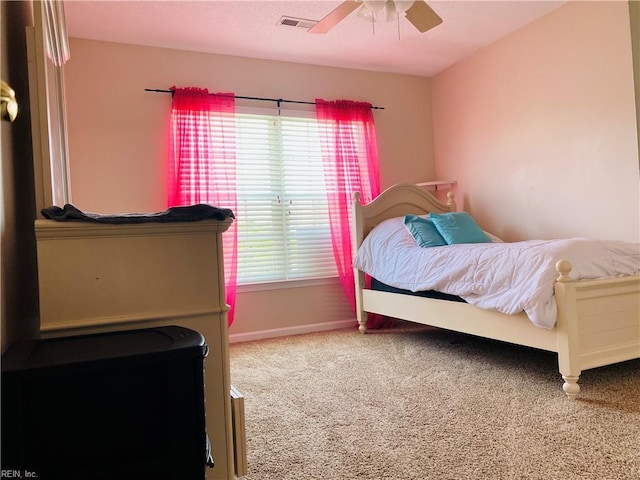 carpeted bedroom featuring a ceiling fan, baseboards, and visible vents