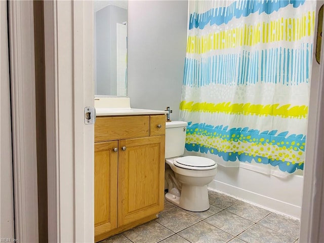bathroom with vanity, tile patterned floors, shower / bath combination with curtain, and toilet