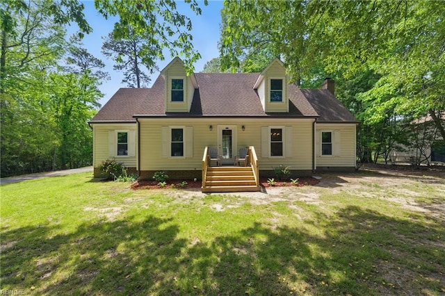 view of front of home with a chimney, a front yard, and a wooden deck