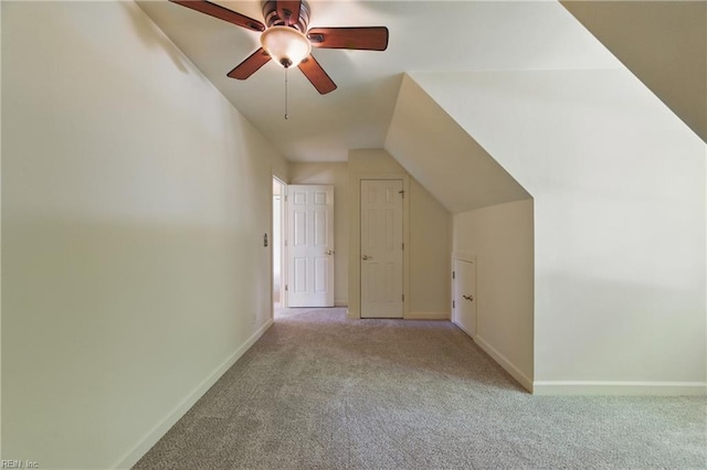 additional living space with baseboards, carpet flooring, ceiling fan, and vaulted ceiling