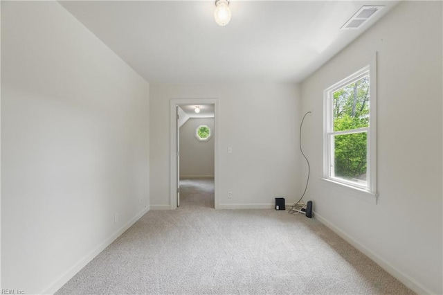 spare room featuring visible vents, carpet flooring, and baseboards