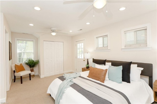 bedroom featuring recessed lighting, baseboards, light carpet, and a closet