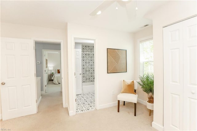 sitting room with light colored carpet, baseboards, ceiling fan, and visible vents