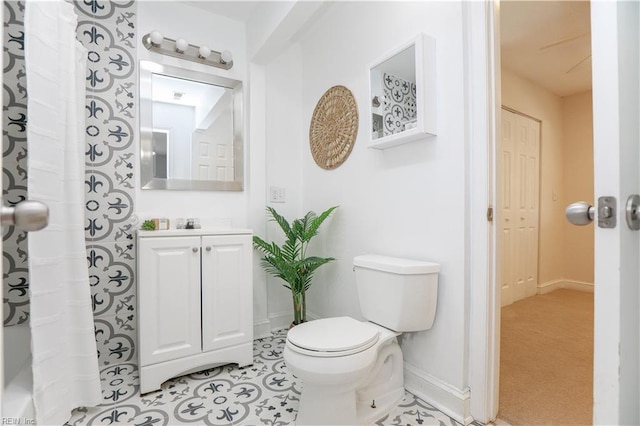 bathroom with toilet, baseboards, and vanity